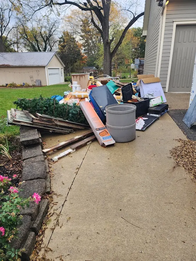 Dumpster being loaded with debris for 12 Yard Dumpster Rental in Shelby